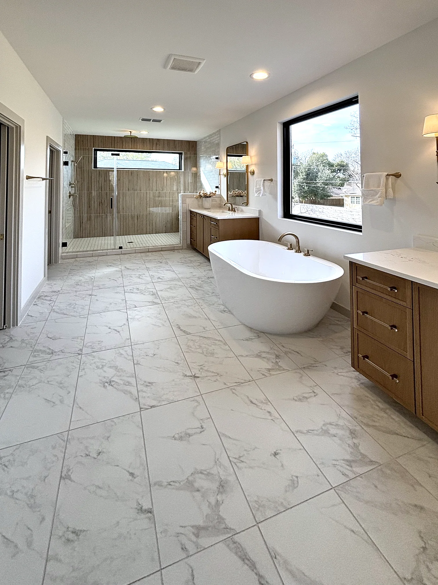 Primary bathroom with sconces flanking the vanity mirror