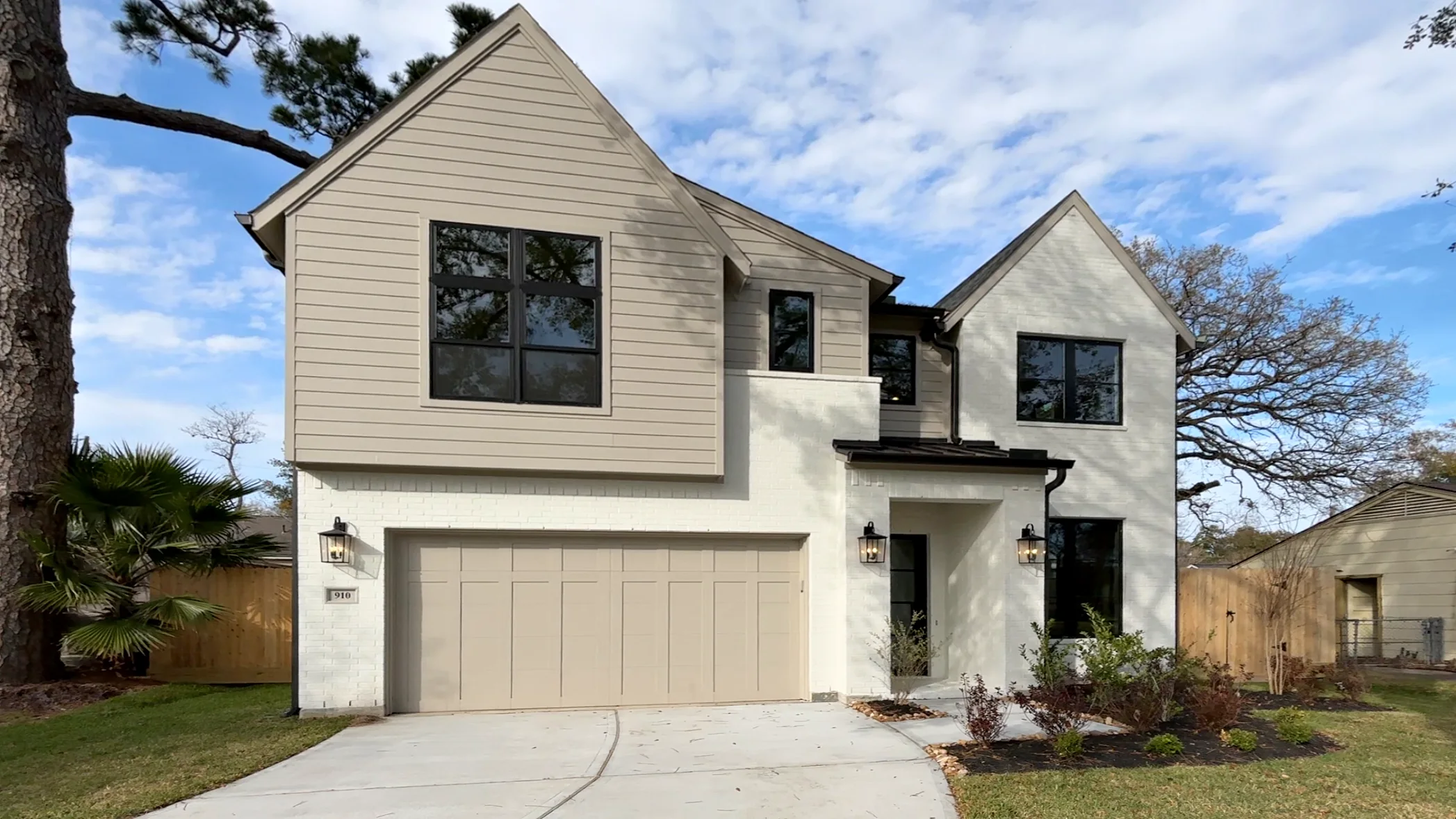 Modern Houston home exterior with lantern wall sconces